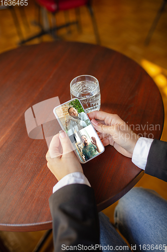 Image of Remote working. Workplace in bar, restaurant office with PC, devices and gadgets.