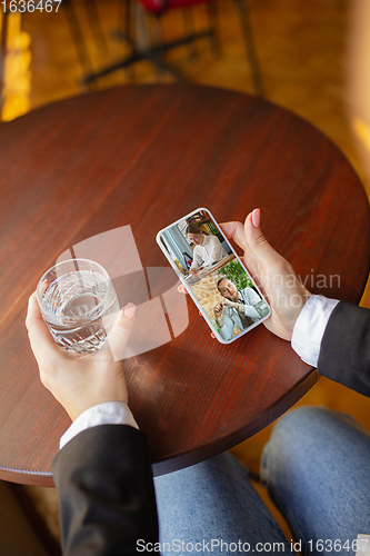 Image of Remote working. Workplace in bar, restaurant office with PC, devices and gadgets.