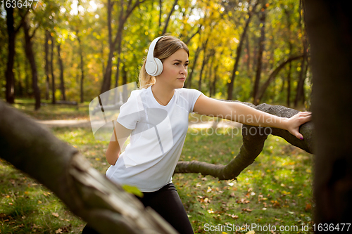 Image of Disabled woman walking down and training outdoors in forest