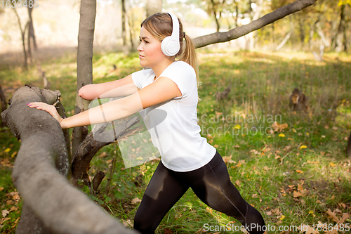 Image of Disabled woman walking down and training outdoors in forest