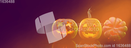 Image of Scary pumpkins on dark orange background, the night of fear