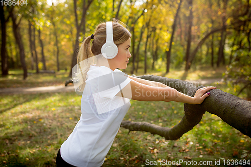 Image of Disabled woman walking down and training outdoors in forest