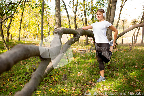 Image of Disabled woman walking down and training outdoors in forest