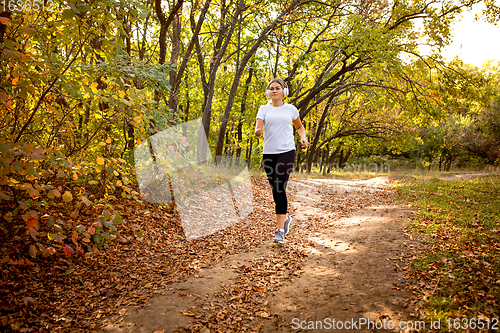 Image of Disabled woman walking down and training outdoors in forest