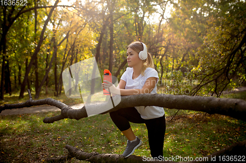 Image of Disabled woman walking down and training outdoors in forest