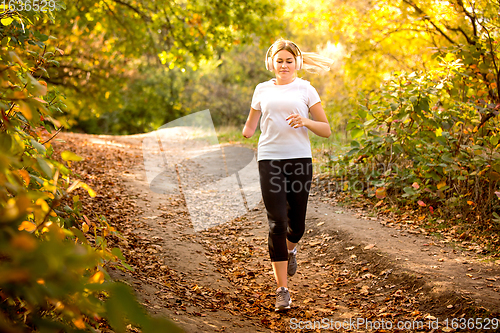 Image of Disabled woman walking down and training outdoors in forest