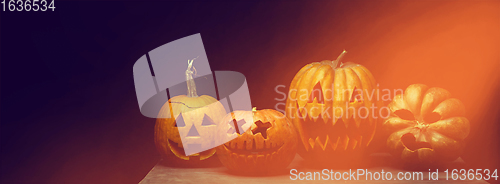 Image of Scary pumpkins on dark orange background, the night of fear