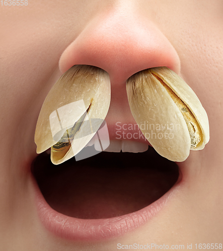 Image of Close up human nose with allergen causes a runny nose and sneezing