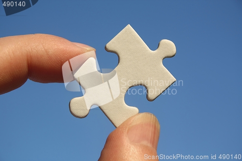 Image of Jigsaw Puzzle in Human Fingers