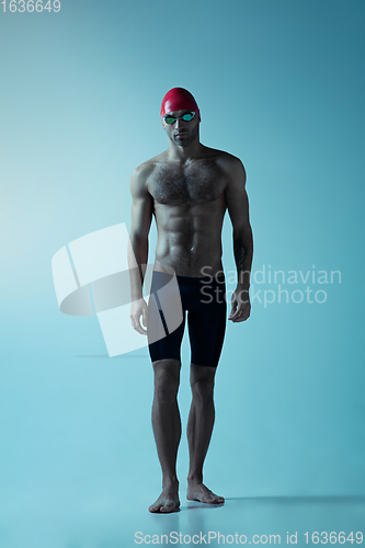 Image of Professional male swimmer with hat and goggles in motion and action, healthy lifestyle and movement concept. Neoned style.