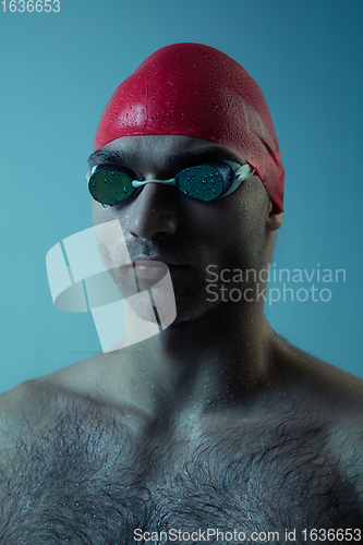 Image of Professional male swimmer with hat and goggles in motion and action, healthy lifestyle and movement concept. Neoned style.