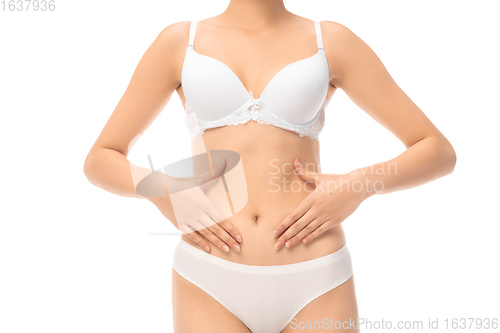 Image of Beautiful female belly and chest isolated on white background. Beauty, cosmetics, spa, depilation, treatment and fitness concept, sensual posing