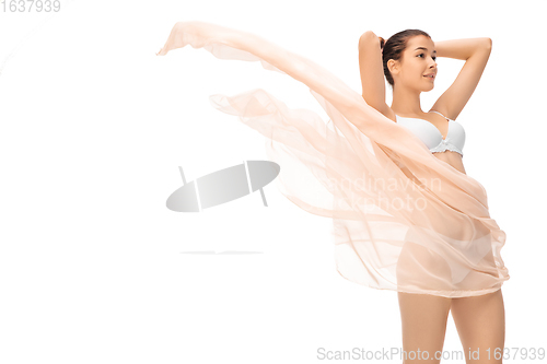 Image of Beautiful woman with light flying cloth isolated on white background. Beauty, cosmetics, spa, depilation, treatment and fitness concept, sensual posing