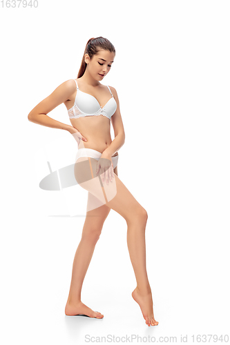 Image of Beautiful woman in underwear isolated on white background. Beauty, cosmetics, spa, depilation, diet, treatment and fitness concept, sensual posing