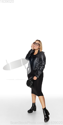 Image of Beautiful young woman in black attire, stylish outfit isolated on white studio background