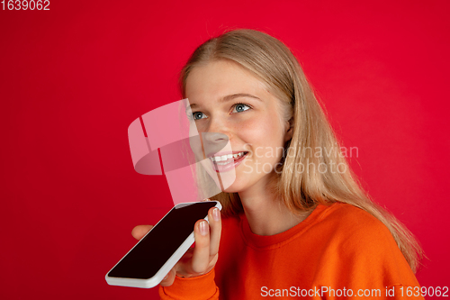 Image of Portrait of young caucasian woman with bright emotions isolated on red studio background