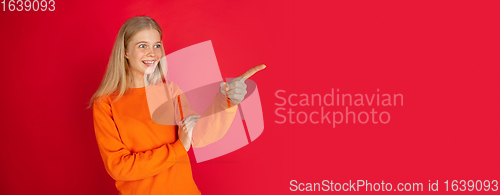 Image of Portrait of young caucasian woman with bright emotions isolated on red studio background