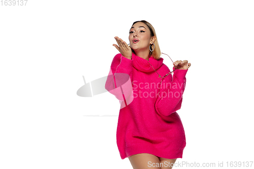 Image of Beautiful young woman in bright pink comfortable sweater, long sleeve isolated on white studio background