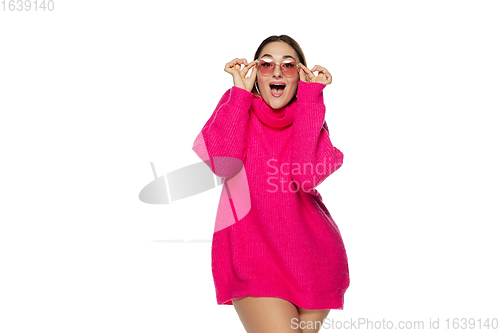 Image of Beautiful young woman in bright pink comfortable sweater, long sleeve isolated on white studio background