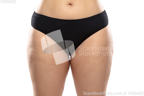 Image of Overweight woman with fat cellulite legs and buttocks, obesity female body in black underwear isolated on white background