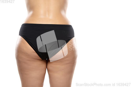 Image of Overweight woman with fat cellulite legs and buttocks, obesity female body in black underwear isolated on white background