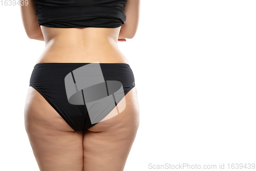 Image of Overweight woman with fat cellulite legs and buttocks, obesity female body in black underwear isolated on white background