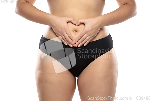 Image of Overweight woman with fat cellulite legs and buttocks, obesity female body in black underwear isolated on white background