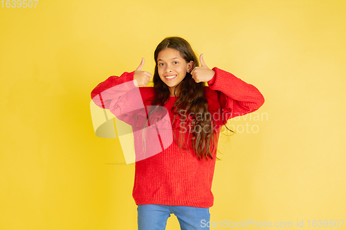 Image of Portrait of young caucasian teen girl with bright emotions isolated on yellow studio background