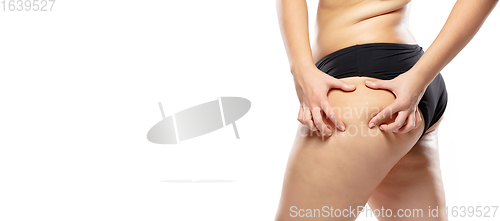 Image of Overweight woman with fat cellulite legs and buttocks, obesity female body in black underwear isolated on white background