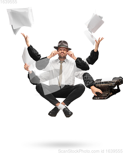 Image of Handsome multi-armed journalist levitating isolated on yellow studio background with equipment