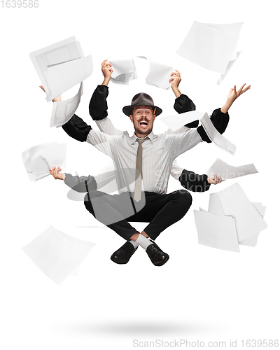 Image of Handsome multi-armed journalist levitating isolated on yellow studio background with equipment