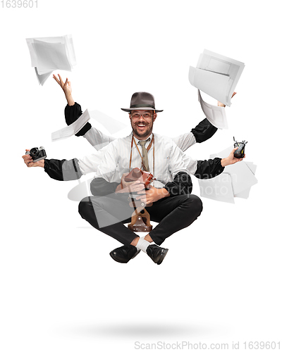 Image of Handsome multi-armed journalist levitating isolated on yellow studio background with equipment