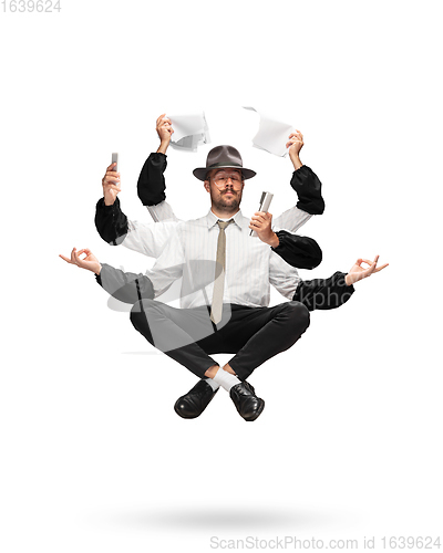 Image of Handsome multi-armed journalist levitating isolated on yellow studio background with equipment