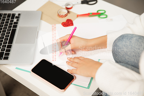 Image of Woman making greeting card for New Year and Christmas 2021 for friends or family, scrap booking, DIY