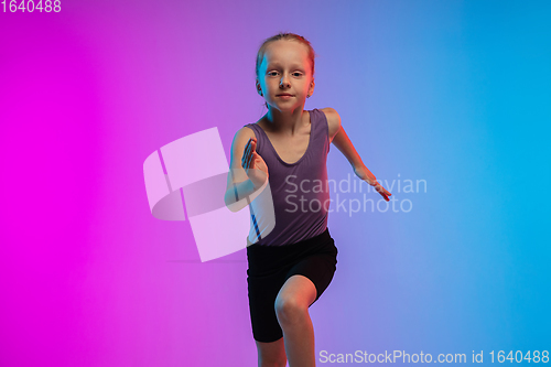 Image of Teenage girl running, jogging against gradient pink-blue neon studio background in motion