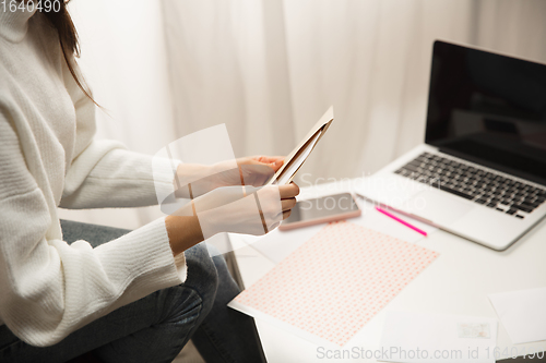 Image of Woman opening, recieving greeting card for New Year and Christmas 2021 from friends or family