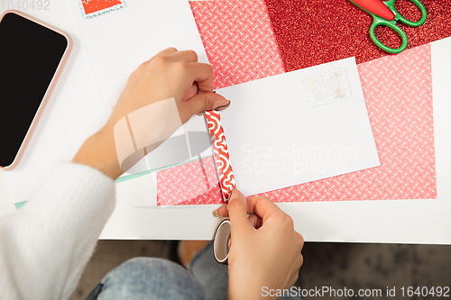 Image of Woman making greeting card for New Year and Christmas 2021 for friends or family, scrap booking, DIY