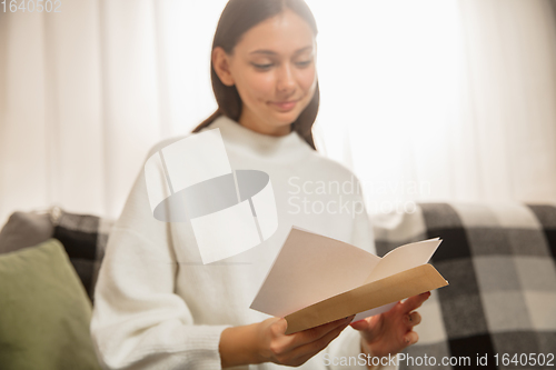 Image of Woman opening, recieving greeting card for New Year and Christmas 2021 from friends or family