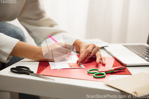 Image of Woman making greeting card for New Year and Christmas 2021 for friends or family, scrap booking, DIY