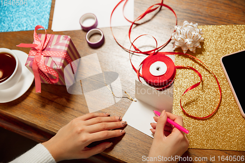 Image of Woman making greeting card for New Year and Christmas 2021 for friends or family, scrap booking, DIY