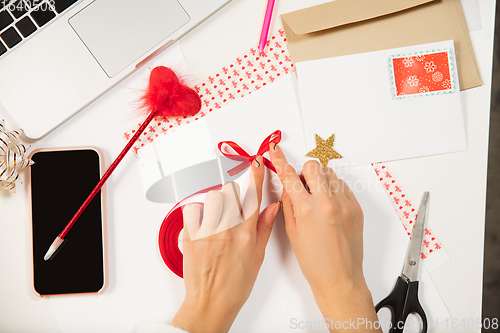 Image of Woman making greeting card for New Year and Christmas 2021 for friends or family, scrap booking, DIY