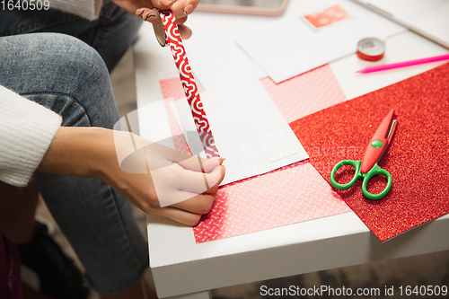 Image of Woman making greeting card for New Year and Christmas 2021 for friends or family, scrap booking, DIY