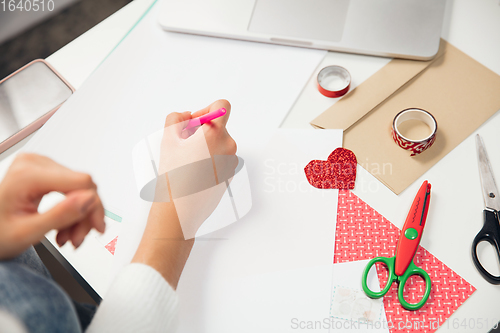 Image of Woman making greeting card for New Year and Christmas 2021 for friends or family, scrap booking, DIY