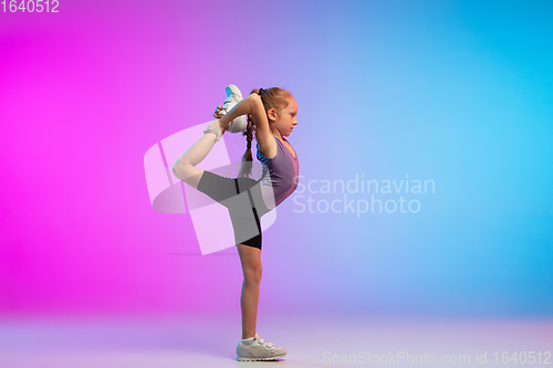 Image of Teenage girl running, jogging against gradient pink-blue neon studio background in motion