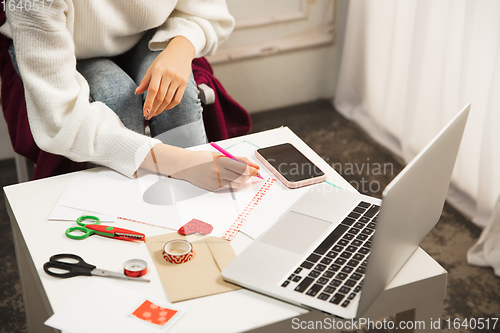 Image of Woman making greeting card for New Year and Christmas 2021 for friends or family, scrap booking, DIY