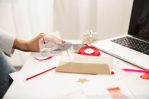 Image of Woman making greeting card for New Year and Christmas 2021 for friends or family, scrap booking, DIY