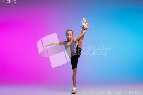 Image of Teenage girl running, jogging against gradient pink-blue neon studio background in motion