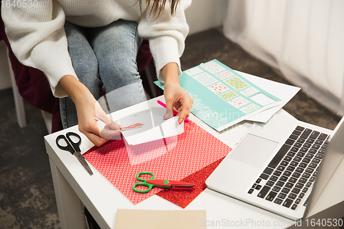 Image of Woman making greeting card for New Year and Christmas 2021 for friends or family, scrap booking, DIY