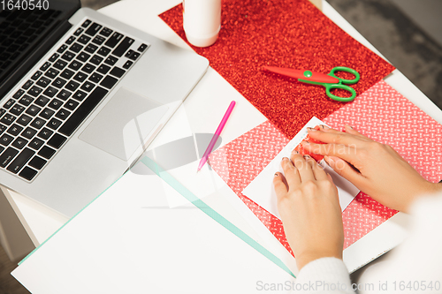 Image of Woman making greeting card for New Year and Christmas 2021 for friends or family, scrap booking, DIY