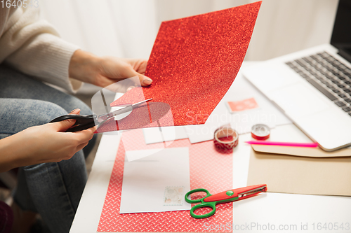 Image of Woman making greeting card for New Year and Christmas 2021 for friends or family, scrap booking, DIY